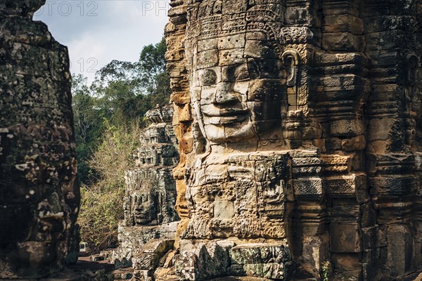 Dilapidated statue and pillar at Angkor Wat