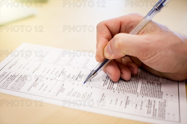 Caucasian businessman writing paperwork