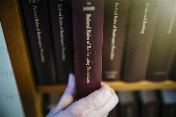 Caucasian woman selecting reference book from shelf