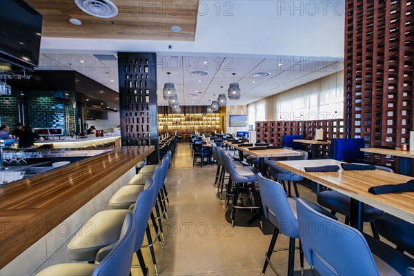 Tables and chairs in modern bar and restaurant