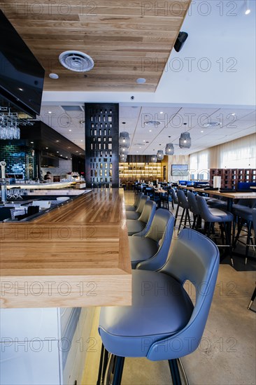 Tables and chairs in modern bar and restaurant