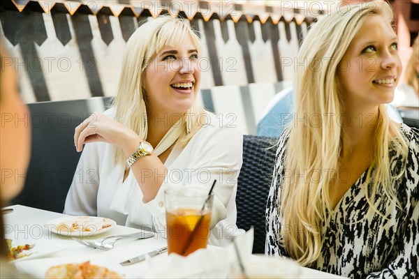 Caucasian customers smiling in restaurant