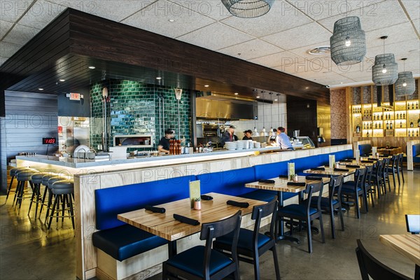 Busy workers at counter in modern bar and restaurant