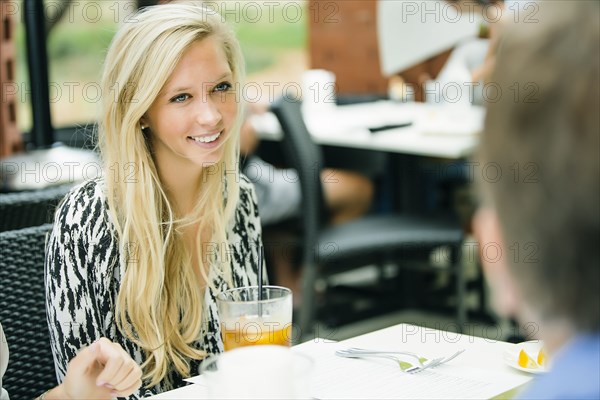 Smiling Caucasian woman sitting at restaurant table