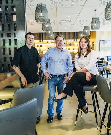 Caucasian men and woman smiling in restaurant