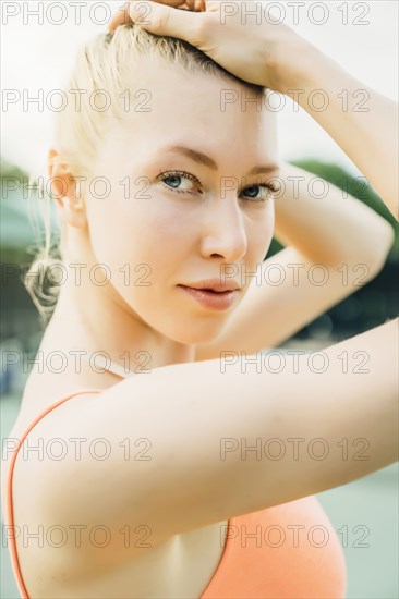 Caucasian woman posing with hands in hair