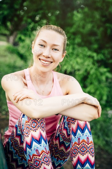 Smiling Caucasian woman sitting outdoors