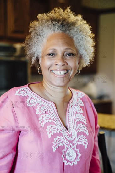Black woman smiling in domestic kitchen