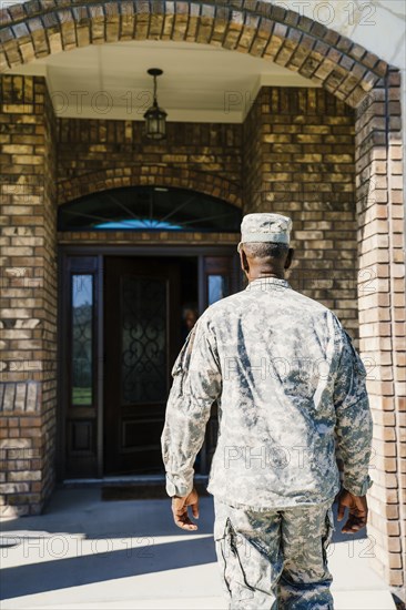 Black soldier approaching doorway