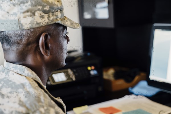 Black soldier using computer