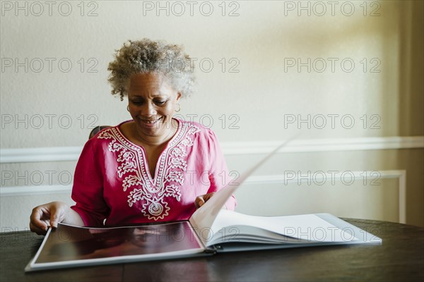 Black woman enjoying photo album