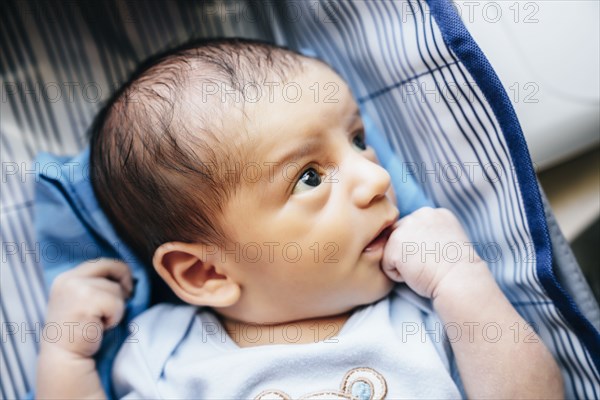 Curious baby boy looking up