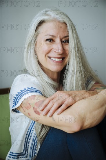 Caucasian woman sitting in armchair