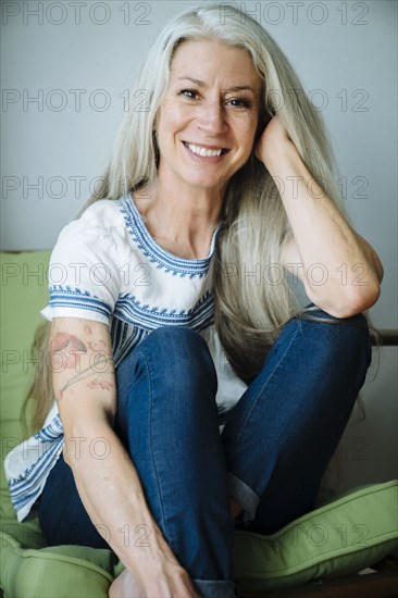 Caucasian woman sitting in armchair