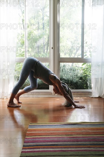 Caucasian woman bending on floor stretching