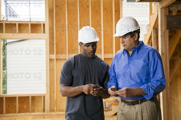 Construction workers texting on cell phones