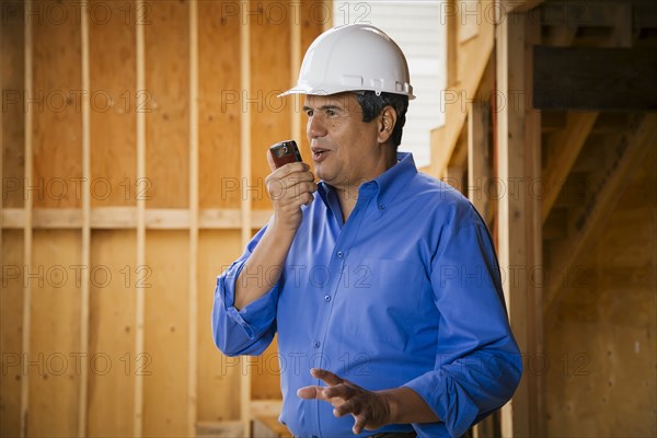 Native American construction worker talking on cell phone