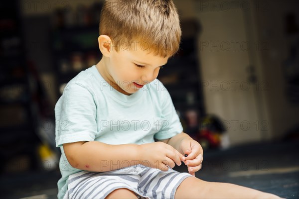 Caucasian boy holding small marble