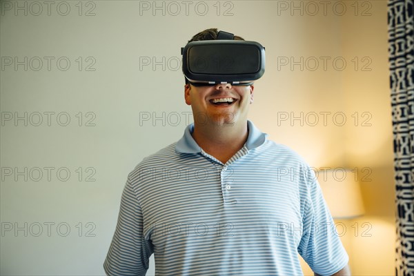 Caucasian man wearing virtual reality goggles