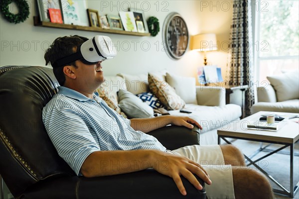 Caucasian man wearing virtual reality goggles