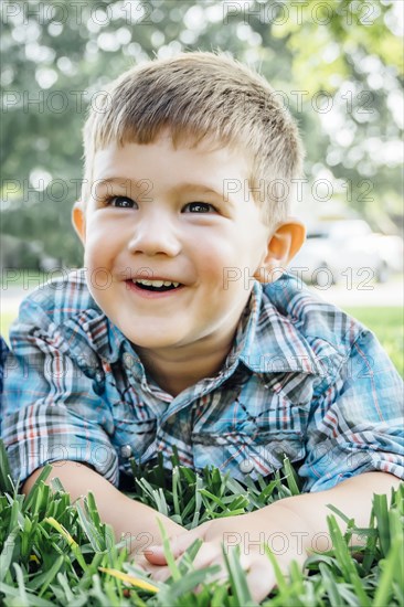 Smiling Caucasian boy posing in grass