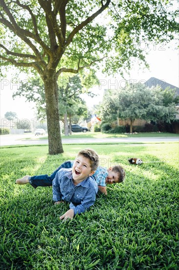 Smiling Caucasian boys playing in grass