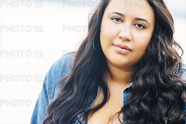 Serious Mixed Race woman near ocean