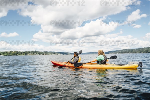 Man and woman paddling kayak