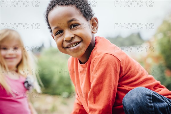 Portrait of smiling boy and girl outdoors