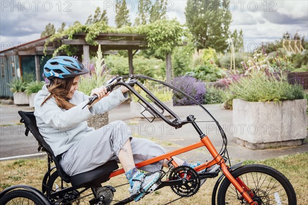 Caucasian woman riding tricycle