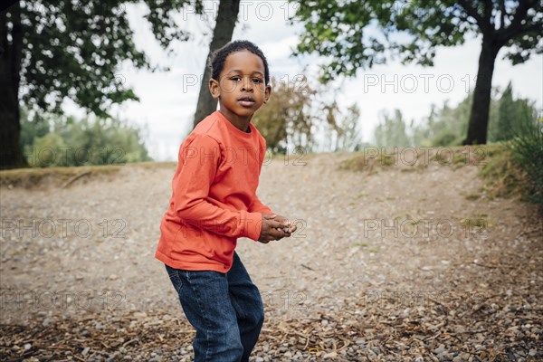 Black boy holding stone