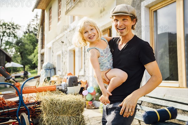 Caucasian man carrying daughter