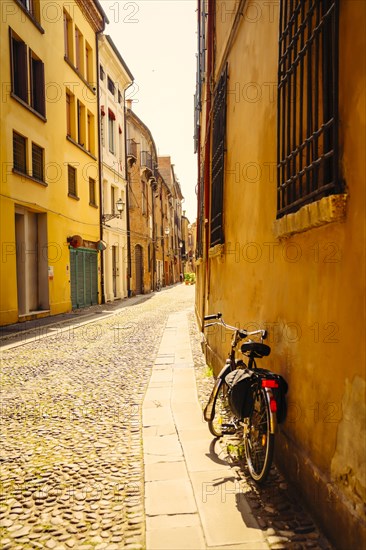 Bicycle leaning in building near street