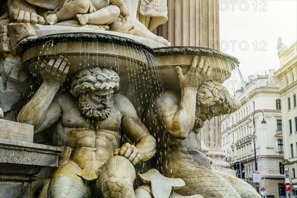 Statue of male likenesses in fountain