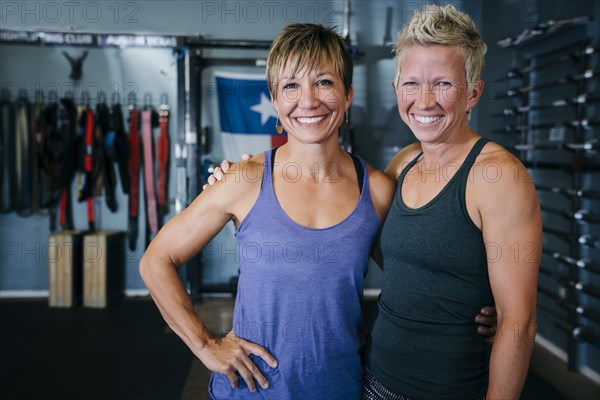 Smiling Caucasian women posing in gymnasium