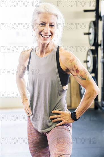 Caucasian woman smiling in gymnasium