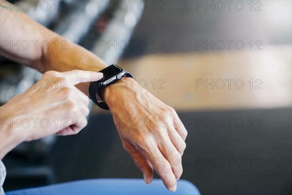 Caucasian woman tapping smart watch