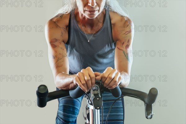 Caucasian woman riding stationary bicycle