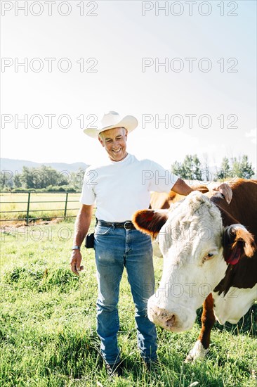 Caucasian farmer petting cow