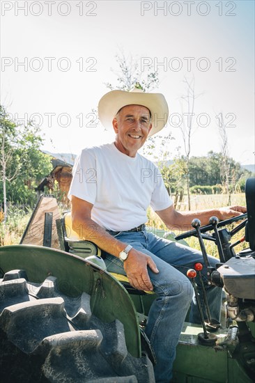 Caucasian farmer sitting on tractor