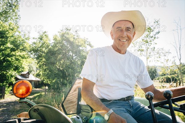 Caucasian farmer sitting on tractor