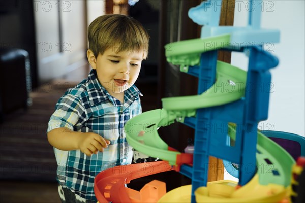 Boy playing with spiral track toy