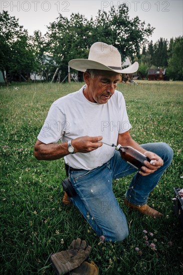 Caucasian farmer preparing vaccine in syringe