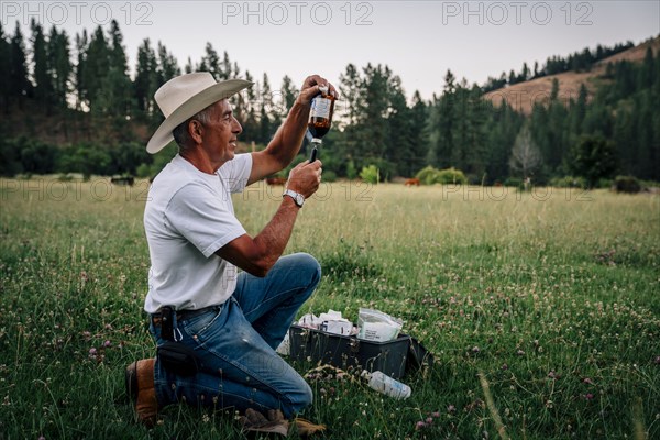 Caucasian farmer preparing vaccine in syringe