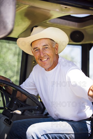 Portrait of smiling Caucasian farmer in tractor