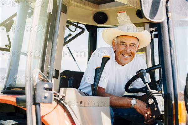 Portrait of smiling Caucasian farmer in tractor