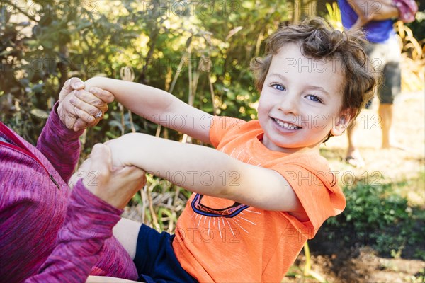 Portrait of Caucasian boy playing with mother