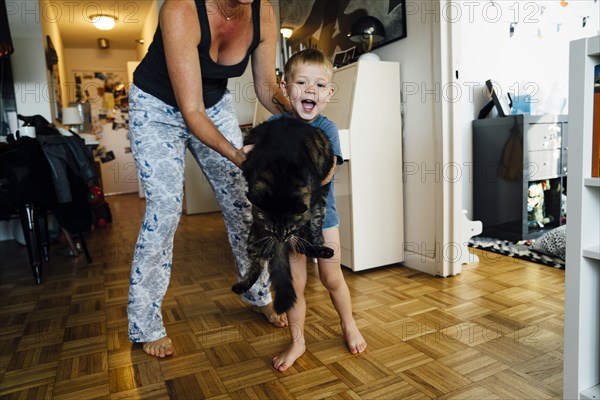 Mother and son holding pet cat