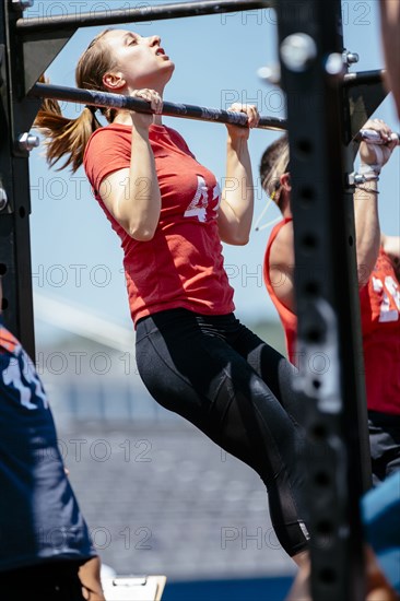 Caucasian woman doing chin-ups