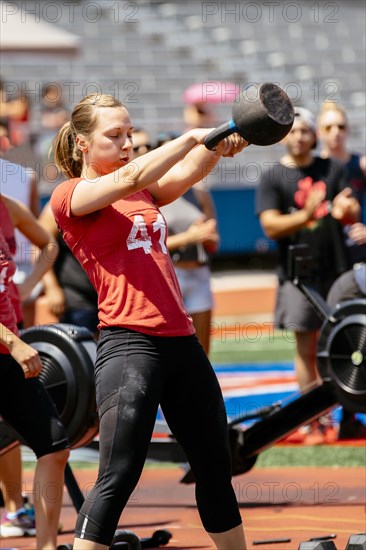 Woman lifting kettlebell outdoors